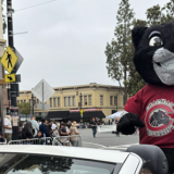 Paws up! Pete the Panther rides through the Orange May Parade, sharing Chapman spirit with the community.